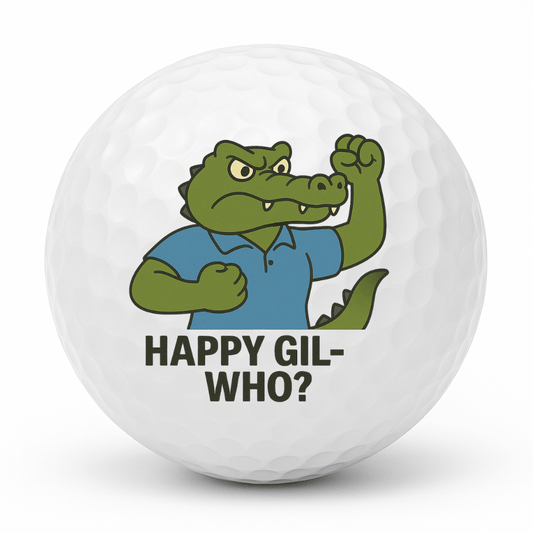 Cartoon crocodile golfer doing a fist pump with the text Happy Gil Who on a white golf ball.